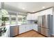 Bright and modern kitchen with stainless steel appliances and white cabinetry at 3843 S Quince St, Denver, CO 80237