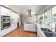 Bright and modern kitchen with stainless steel appliances, granite countertops, and white cabinetry at 3843 S Quince St, Denver, CO 80237