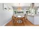 Cozy breakfast nook with a round table, wood chairs, and large windows at 3843 S Quince St, Denver, CO 80237