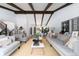 Large open concept living space with exposed beams, neutral colors, and dining area at 3843 S Quince St, Denver, CO 80237