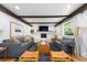 Inviting living room featuring beamed ceilings, a white brick fireplace, and comfortable seating at 3843 S Quince St, Denver, CO 80237