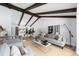 Bright living room featuring vaulted ceilings, exposed beams, and neutral furniture at 3843 S Quince St, Denver, CO 80237