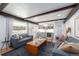 Comfortable living room with a modern bar, beamed ceilings, and large windows offering natural light at 3843 S Quince St, Denver, CO 80237