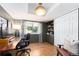 Stylish home office featuring hardwood floors, built-in shelving, and a spacious desk at 3843 S Quince St, Denver, CO 80237