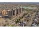Scenic aerial view showcases the apartment building, surrounding neighborhoods, lake, and city skyline at 460 S Marion Pkwy # 1351, Denver, CO 80209