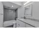 Modern bathroom featuring gray subway tile, granite countertop, and ample lighting above the sink and shower at 460 S Marion Pkwy # 1351, Denver, CO 80209