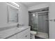 Contemporary bathroom with granite countertop, gray subway tile shower with glass door, and modern fixtures at 460 S Marion Pkwy # 1351, Denver, CO 80209