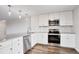Well-lit kitchen with stainless steel appliances, white cabinets, gray countertop, and decorative backsplash at 460 S Marion Pkwy # 1351, Denver, CO 80209