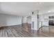 Spacious living room with hardwood floors, white walls, leading into an open-concept kitchen with stainless steel appliances at 460 S Marion Pkwy # 1351, Denver, CO 80209