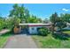 Aerial view of the property shows a well-maintained exterior, yard, and driveway at 1560 Simms St, Lakewood, CO 80215