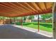 Inviting backyard with a well-manicured lawn, a privacy fence, and a covered patio area for outdoor gatherings at 1560 Simms St, Lakewood, CO 80215