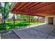 A lush green backyard with a well-maintained lawn and a spacious covered patio, perfect for outdoor enjoyment at 1560 Simms St, Lakewood, CO 80215