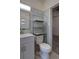 Charming bathroom shows a toilet with shelving, complemented by blue tiled walls at 1560 Simms St, Lakewood, CO 80215