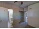 Bedroom with open closet, neutral walls, doorway to the bathroom, and carpeted floor at 1560 Simms St, Lakewood, CO 80215