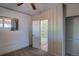 Bedroom featuring neutral walls, a closet, a window, carpeting, and a doorway to the bathroom at 1560 Simms St, Lakewood, CO 80215