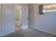 A look inside a bedroom featuring carpeted flooring, window, and a view into an adjacent bathroom at 1560 Simms St, Lakewood, CO 80215