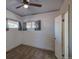 Cozy bedroom with neutral walls and carpeting, featuring a ceiling fan and natural light at 1560 Simms St, Lakewood, CO 80215