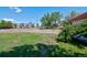 View from the side of this house, showcasing the yard, sidewalk and the street at 1560 Simms St, Lakewood, CO 80215