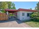 Well-maintained one-story home featuring a gated carport and manicured landscaping for a welcoming curb appeal at 1560 Simms St, Lakewood, CO 80215