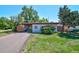 Charming single-story home with a spacious driveway and well-maintained lawn, perfect for a Gathering at 1560 Simms St, Lakewood, CO 80215