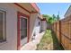 View from the back of this house, showcasing the yard, sidewalk and the street at 1560 Simms St, Lakewood, CO 80215