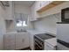 Efficient kitchen with white cabinetry, modern appliances, and plenty of counter space at 1560 Simms St, Lakewood, CO 80215