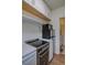 Compact kitchen with new appliances, white cabinets, and plenty of countertop space at 1560 Simms St, Lakewood, CO 80215