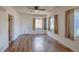 Bright living room featuring hardwood floors, updated fixtures, and lots of natural light at 1560 Simms St, Lakewood, CO 80215
