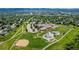 This aerial view shows the school playground, baseball field, and surrounding community at 551 Snowy Owl Pl, Highlands Ranch, CO 80126