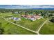 An aerial shot of a school surrounded by green fields, pathways, and residential areas at 551 Snowy Owl Pl, Highlands Ranch, CO 80126