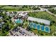 This aerial shows a community pool, tennis courts, and parking at 551 Snowy Owl Pl, Highlands Ranch, CO 80126