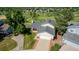 Aerial view of a home featuring a well-maintained yard, brick-lined driveway, and attached two car garage at 551 Snowy Owl Pl, Highlands Ranch, CO 80126