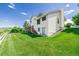 Expansive backyard features a lush green lawn and the back of the home at 551 Snowy Owl Pl, Highlands Ranch, CO 80126