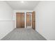 A comfortable bedroom features neutral carpet and wooden closet doors at 551 Snowy Owl Pl, Highlands Ranch, CO 80126