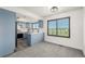 Dining area with modern blue cabinets, stainless appliances, and a large window with a view at 551 Snowy Owl Pl, Highlands Ranch, CO 80126