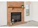 Living room featuring a brick fireplace with a wooden mantel and a view of the backyard at 551 Snowy Owl Pl, Highlands Ranch, CO 80126