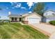 Charming single-Gathering home featuring a manicured lawn and an attached two-car garage with white doors at 551 Snowy Owl Pl, Highlands Ranch, CO 80126
