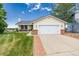 Charming single-Gathering home featuring a manicured lawn and an attached two-car garage with white doors at 551 Snowy Owl Pl, Highlands Ranch, CO 80126