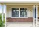 View of the front window with brick siding and white shutters at 551 Snowy Owl Pl, Highlands Ranch, CO 80126