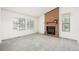 Bright living room featuring a brick fireplace with a wooden mantel at 551 Snowy Owl Pl, Highlands Ranch, CO 80126