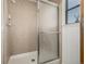 Tiled shower with glass door, next to a window at 551 Snowy Owl Pl, Highlands Ranch, CO 80126