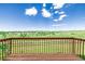 A relaxing wooden deck overlooks the stunning, expansive green and blue views at 551 Snowy Owl Pl, Highlands Ranch, CO 80126
