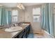 Bathroom featuring a double sink vanity with modern fixtures and a mosaic tile backsplash at 23593 E Chenango Pl, Aurora, CO 80016