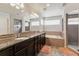 Bathroom features a double sink vanity, soaking tub, and tiled shower at 23593 E Chenango Pl, Aurora, CO 80016