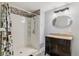 Bathroom showcasing a walk-in shower with a decorative curtain and modern vanity with a granite countertop at 23593 E Chenango Pl, Aurora, CO 80016