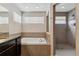 Bathroom features a soaking tub, walk-in shower, and large windows at 23593 E Chenango Pl, Aurora, CO 80016