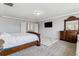 Spacious bedroom features a decorative dresser, TV, walk-in closet, and neutral carpet at 23593 E Chenango Pl, Aurora, CO 80016