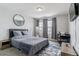 Bedroom features a queen bed, round mirror and small writing desk at 23593 E Chenango Pl, Aurora, CO 80016