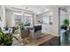 Cozy dining room with a glass table, comfortable chairs, and lots of plants at 23593 E Chenango Pl, Aurora, CO 80016