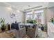 Dining room with a modern glass table, comfortable seating, and an abundance of natural light at 23593 E Chenango Pl, Aurora, CO 80016